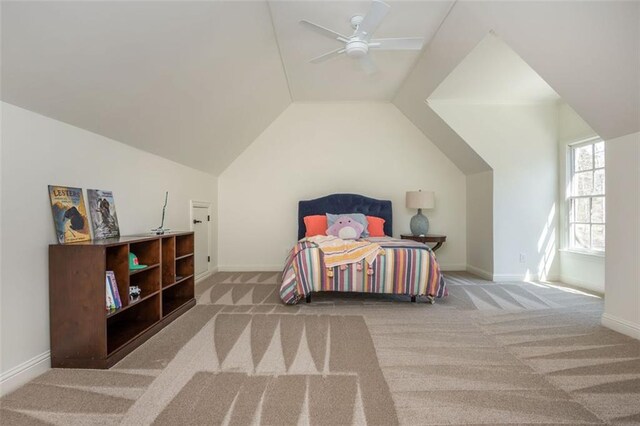 carpeted bedroom with a ceiling fan, baseboards, and lofted ceiling