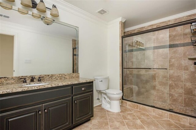 bathroom featuring visible vents, a stall shower, toilet, and vanity