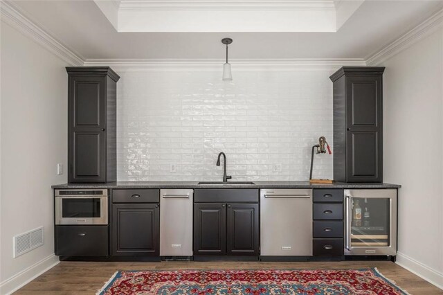 bar with wine cooler, a raised ceiling, a sink, and visible vents