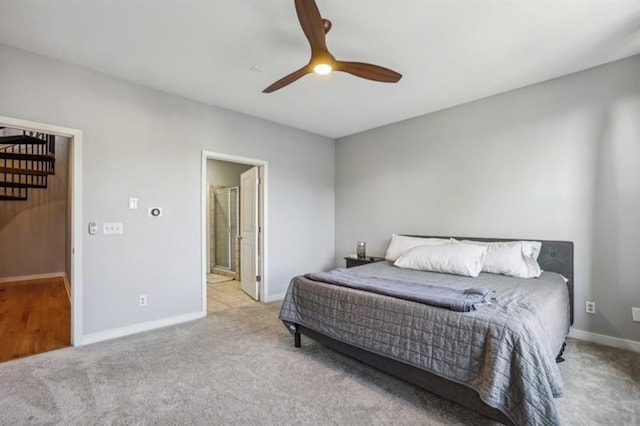 bedroom with light carpet, connected bathroom, and ceiling fan