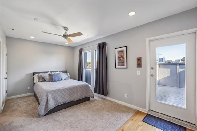 bedroom featuring light hardwood / wood-style floors, ceiling fan, and access to outside