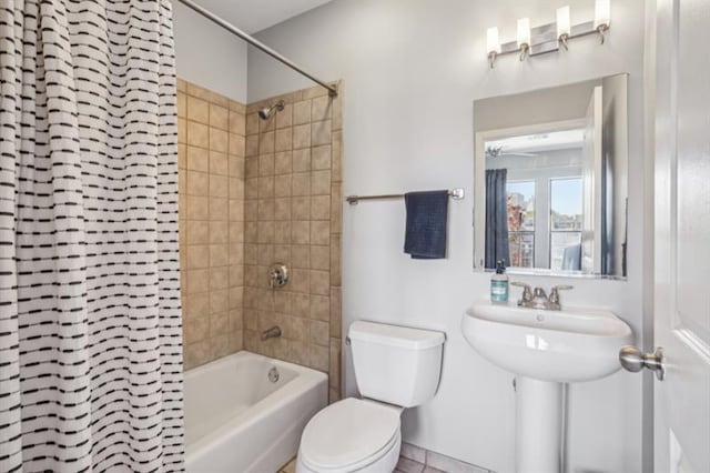 bathroom featuring toilet and tiled shower / bath