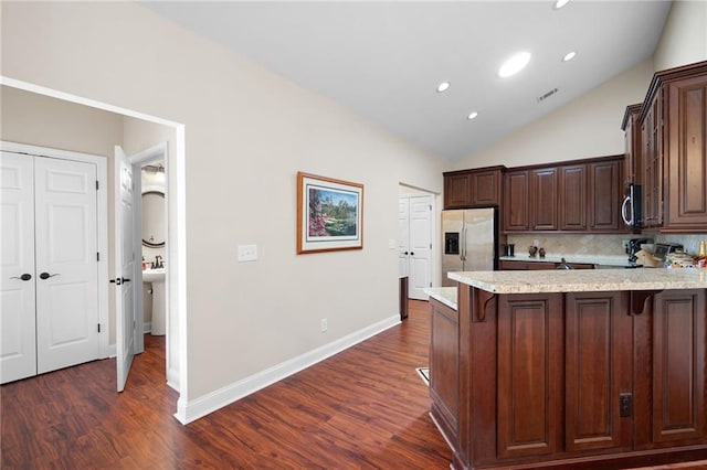 120 Chastain Rd NW Unit 1204, Kennesaw, GA 30144 - kitchen with a breakfast bar area, a peninsula, lofted ceiling, stainless steel appliances, and visible vents