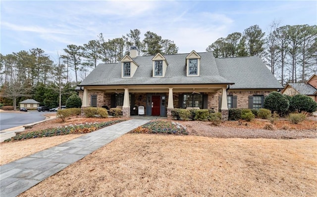 120 Chastain Rd NW Unit 1204, Kennesaw, GA 30144 - view of front of home with a chimney, covered porch, brick siding, and roof with shingles