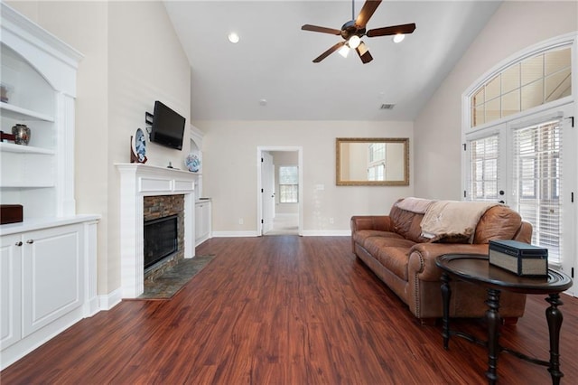 120 Chastain Rd NW Unit 1204, Kennesaw, GA 30144 - living area featuring a ceiling fan, a fireplace, baseboards, visible vents, and dark wood-type flooring