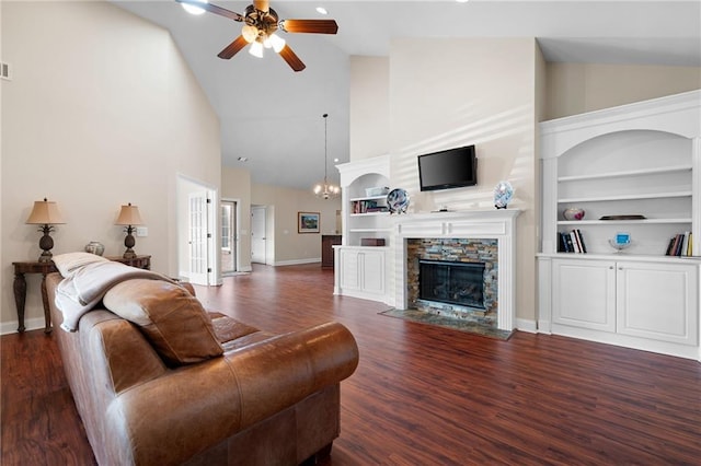 120 Chastain Rd NW Unit 1204, Kennesaw, GA 30144 - living area featuring built in shelves, a fireplace, wood finished floors, baseboards, and ceiling fan with notable chandelier