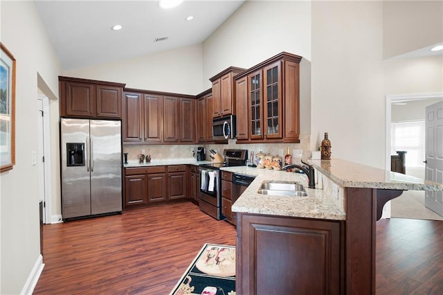 120 Chastain Rd NW Unit 1204, Kennesaw, GA 30144 - kitchen featuring a sink, light stone countertops, a peninsula, dark wood finished floors, and stainless steel appliances