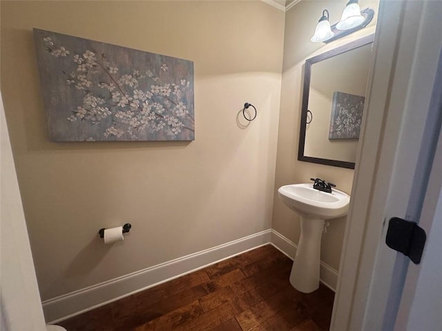 bathroom with baseboards and hardwood / wood-style floors