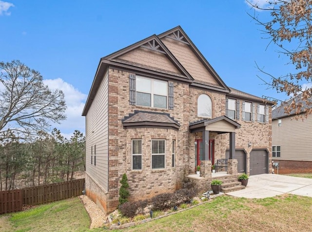 view of front of home featuring a front yard, fence, concrete driveway, a garage, and brick siding