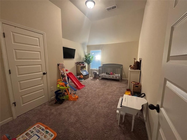 bedroom with visible vents, baseboards, lofted ceiling, carpet flooring, and a nursery area