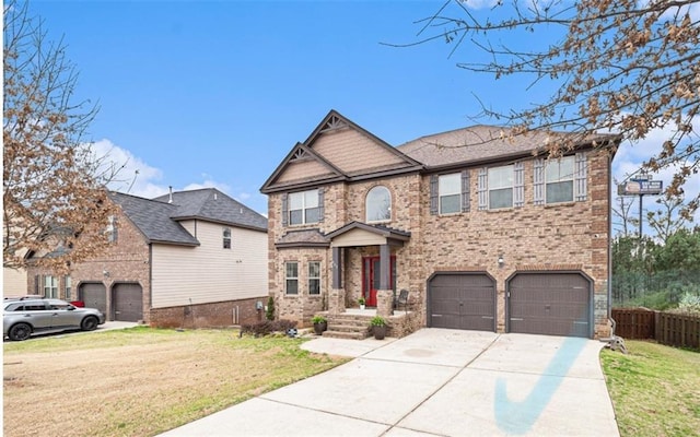 craftsman-style house with brick siding, a front lawn, fence, concrete driveway, and a garage