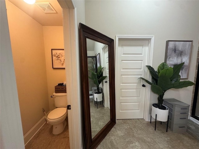 bathroom featuring visible vents, toilet, and baseboards