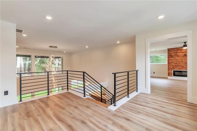 2808 S Arbor Dr, Gainesville, GA 30507 - empty room featuring wood finished floors, recessed lighting, baseboards, a stone fireplace, and ceiling fan