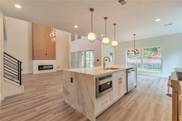 2808 S Arbor Dr, Gainesville, GA 30507 - kitchen with dishwasher, a sink, a chandelier, light wood-style flooring, and recessed lighting