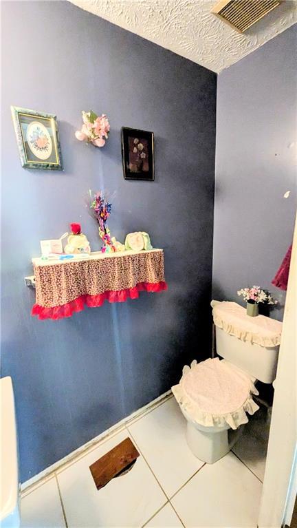 4256 Village Square Ln, Stone Mountain, GA 30083 - bathroom featuring tile patterned floors and toilet
