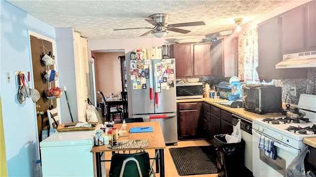 4256 Village Square Ln, Stone Mountain, GA 30083 - kitchen with stainless steel appliances, under cabinet range hood, a textured ceiling, a ceiling fan, and light countertops