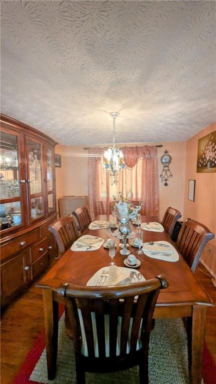 4256 Village Square Ln, Stone Mountain, GA 30083 - dining space with a textured ceiling, dark wood-type flooring, and a chandelier