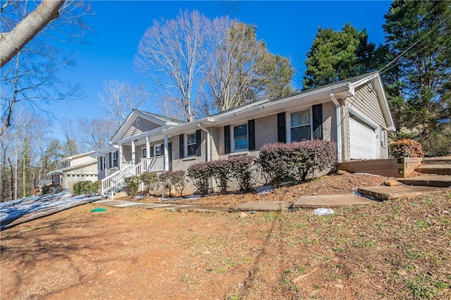 single story home with a garage and covered porch