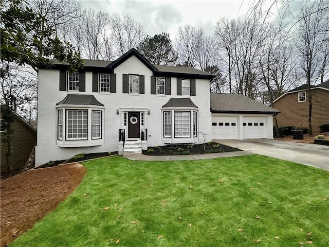 colonial-style house featuring a garage, concrete driveway, brick siding, and a front yard