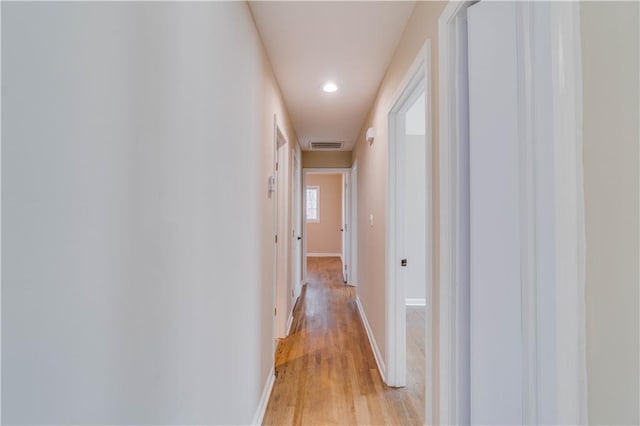 hallway with visible vents, recessed lighting, light wood finished floors, and baseboards
