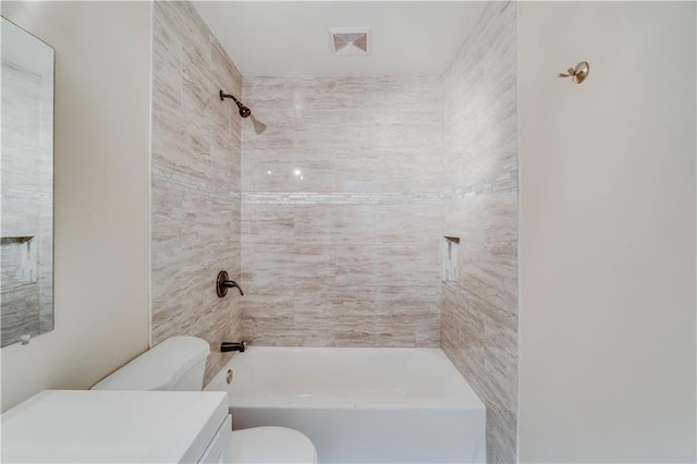 bathroom featuring visible vents, toilet, shower / washtub combination, and vanity