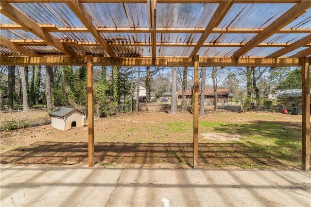 view of yard with an outbuilding, a patio, a storage unit, and fence
