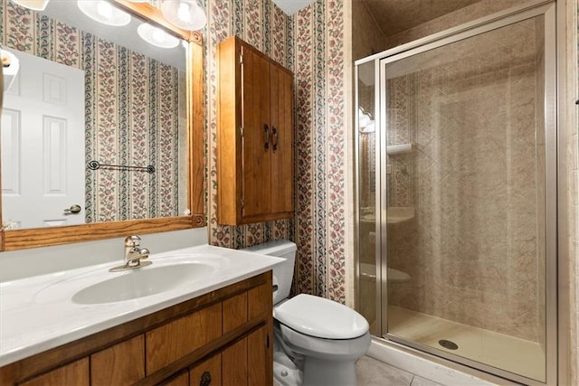 full bath with a stall shower, vanity, toilet, and wallpapered walls