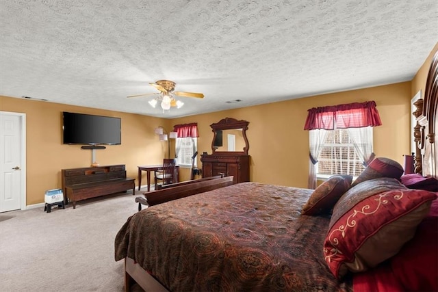 bedroom featuring a textured ceiling, baseboards, and carpet flooring
