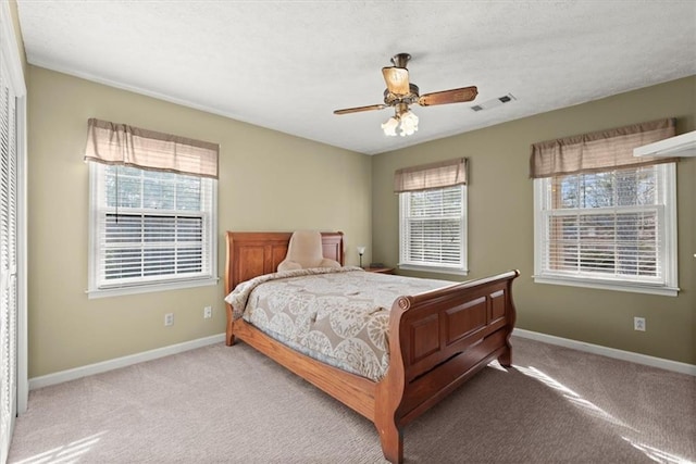 bedroom with multiple windows, visible vents, and baseboards