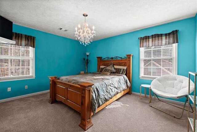 bedroom with carpet, visible vents, a notable chandelier, and multiple windows