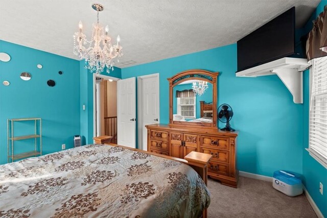bedroom featuring a notable chandelier, carpet, baseboards, and a textured ceiling