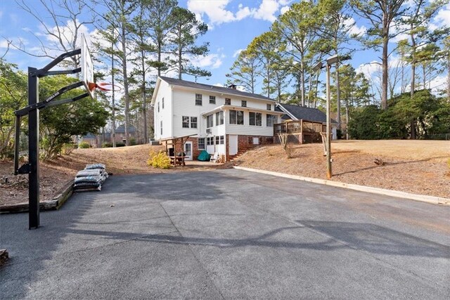 exterior space featuring a sunroom and driveway