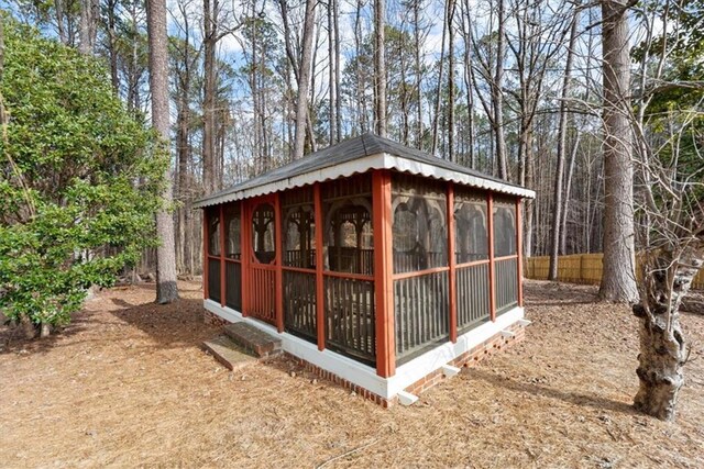 view of outbuilding featuring an outbuilding and fence