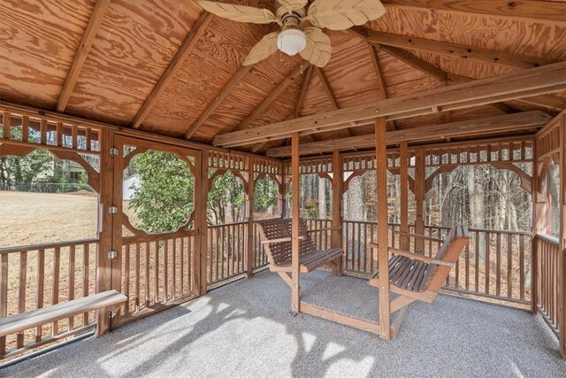 sunroom with a ceiling fan and lofted ceiling