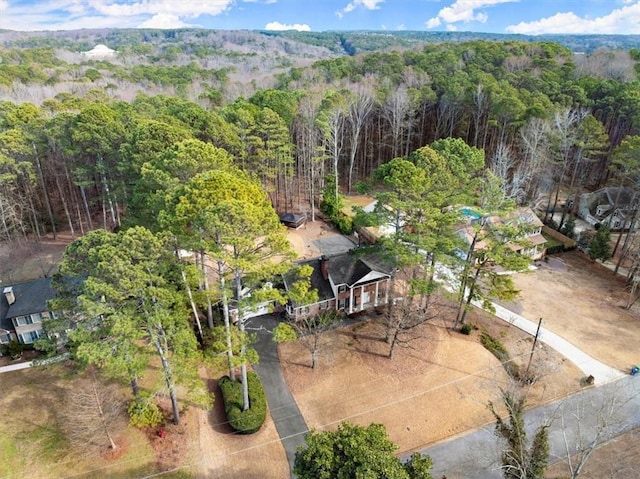 aerial view featuring a wooded view