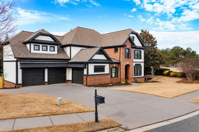 view of front facade featuring driveway, brick siding, and roof with shingles