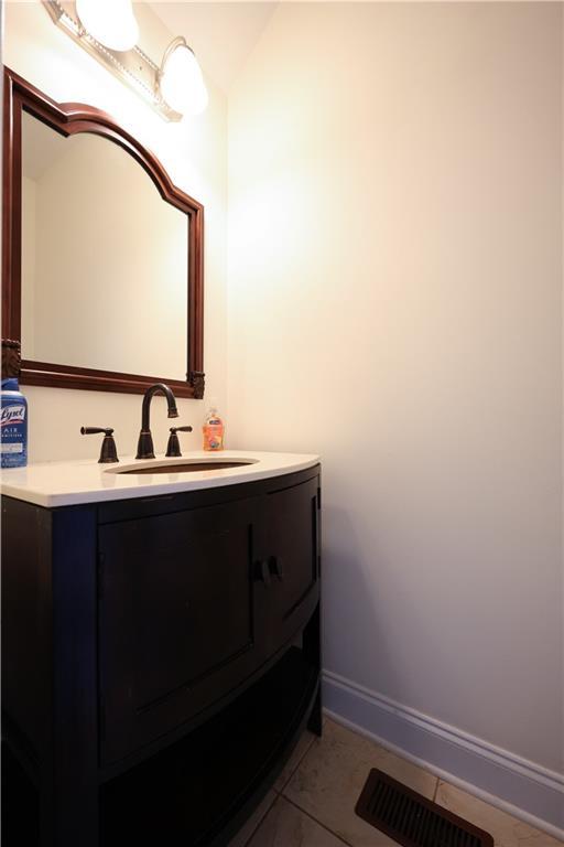 5452 Old Dalton Rd NE, Calhoun, GA 30701 - bathroom with vanity, vaulted ceiling, and tile patterned flooring