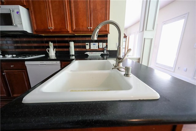 5452 Old Dalton Rd NE, Calhoun, GA 30701 - kitchen view of white appliances, decorative backsplash, and dark countertops