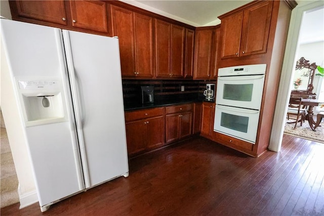5452 Old Dalton Rd NE, Calhoun, GA 30701 - kitchen featuring white appliances, dark wood finished floors, dark countertops, decorative backsplash, and brown cabinetry