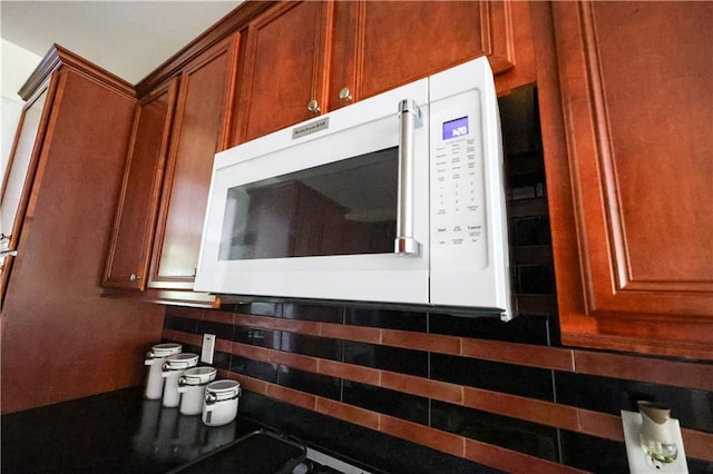 5452 Old Dalton Rd NE, Calhoun, GA 30701 - kitchen view of white microwave, brown cabinetry, and dark countertops