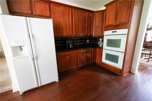 5452 Old Dalton Rd NE, Calhoun, GA 30701 - kitchen with white appliances, dark wood-style floors, brown cabinets, and dark countertops