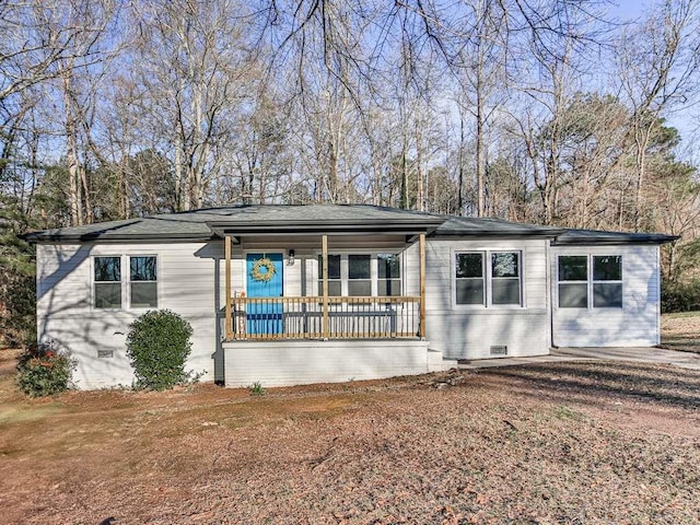 view of front of property with crawl space, brick siding, and a porch