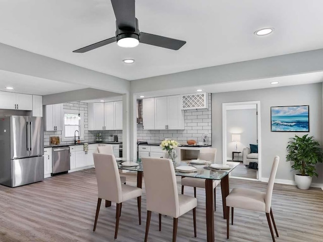 dining space featuring recessed lighting, baseboards, light wood-style floors, and a ceiling fan