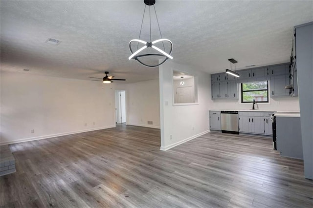 2931 Randolph Ct, Conyers, GA 30012 - kitchen with stainless steel dishwasher, a textured ceiling, baseboards, wood finished floors, and ceiling fan