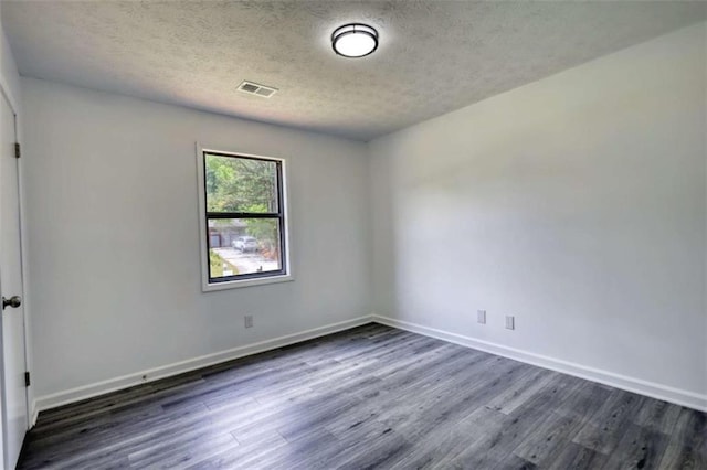 2931 Randolph Ct, Conyers, GA 30012 - empty room featuring dark wood-type flooring, a textured ceiling, and baseboards