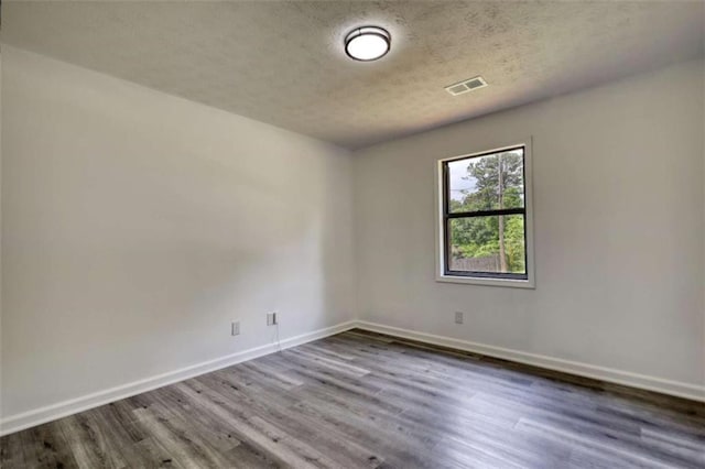 2931 Randolph Ct, Conyers, GA 30012 - empty room featuring dark wood-style flooring, baseboards, and a textured ceiling