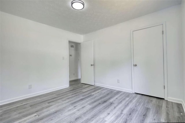 2931 Randolph Ct, Conyers, GA 30012 - unfurnished bedroom featuring wood finished floors, baseboards, and a textured ceiling