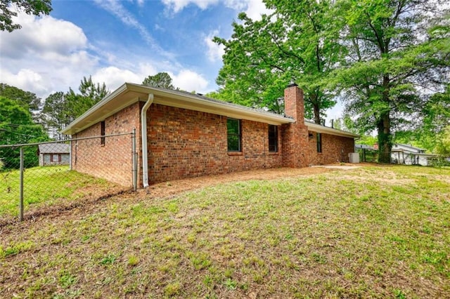 2931 Randolph Ct, Conyers, GA 30012 - back of house featuring a chimney and brick siding