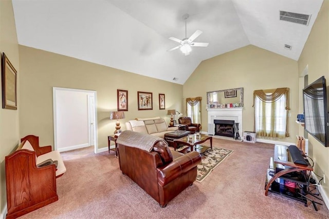 carpeted living room featuring baseboards, visible vents, high vaulted ceiling, a fireplace with flush hearth, and ceiling fan