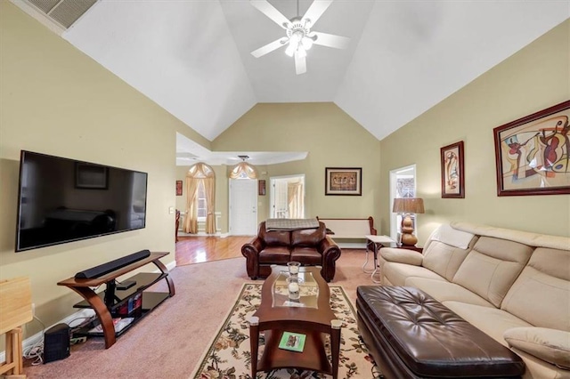 living room featuring visible vents, lofted ceiling, carpet floors, and a ceiling fan